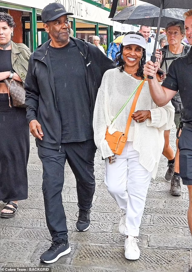 Denzel Washington, 68, puts his arm around wife of 40 years Pauletta Pearson, 72, during a romantic Italian vacation in rainy Portofino